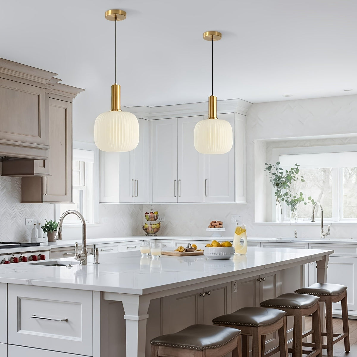 White kitchen with glass pendant lights over the island